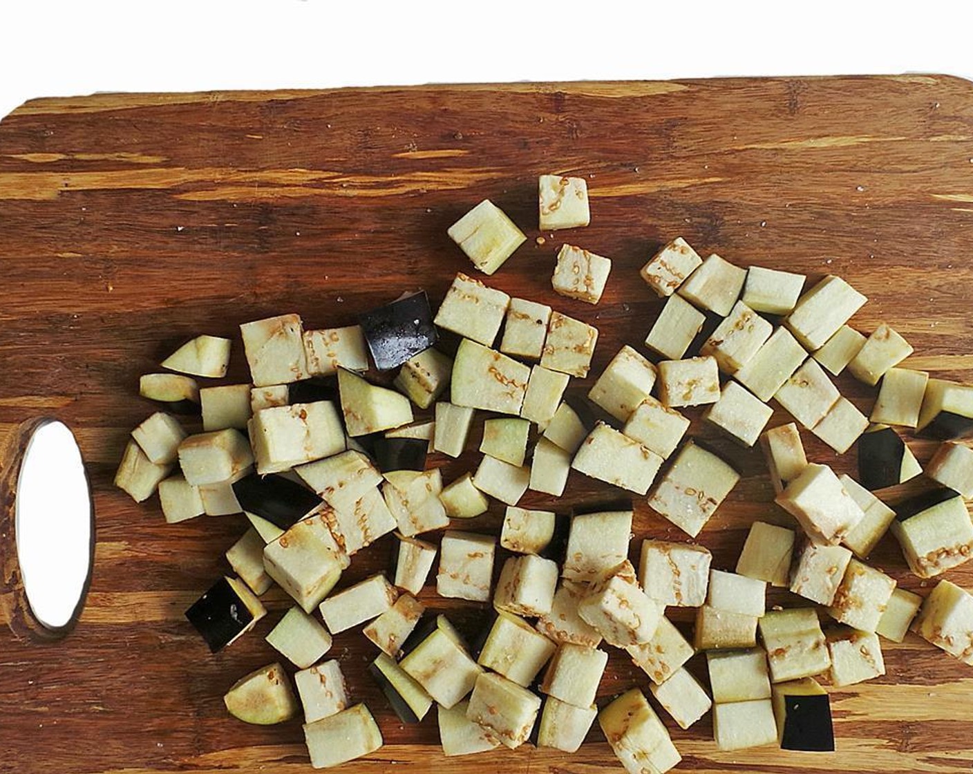 step 4 Rinse and pat the eggplant dry. Cut into cubes and give a good sprinkle of Olive Oil (as needed) and slide in the oven for 20 minutes, flipping around halfway through. They'll be tender and smell yum.