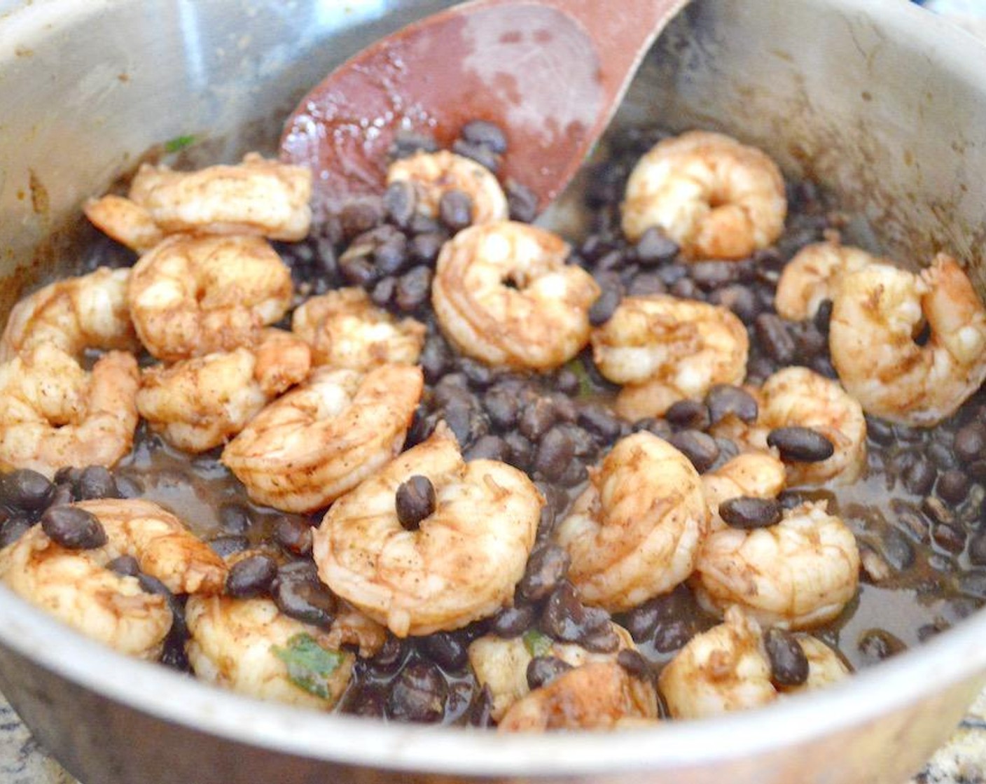 step 5 Add the Black Beans (1 can) and Fresh Cilantro (1 Tbsp). Let the whole mixture bubble gently for another 3-5 minutes to let all of the flavors meld together.