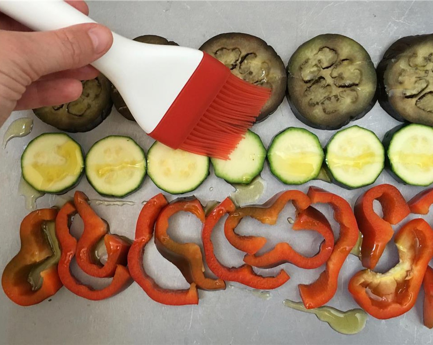 step 3 Place them on a large baking tray. Brush the vegetables evenly with Olive Oil (to taste). Then turn them all and brush again with extra olive oil.