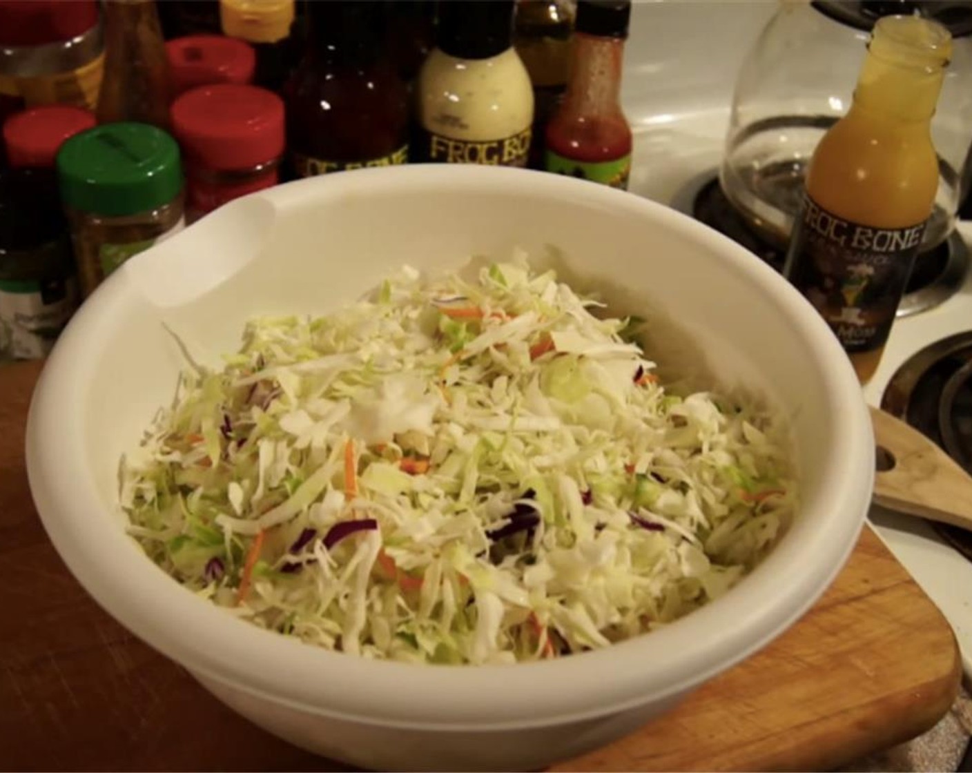 step 8 While pork is cooking, assemble the coleslaw. Place Green Cabbage (1/2 head), Red Cabbage (1/2 head), and Carrot (1) into a large bowl. Mix them together well.