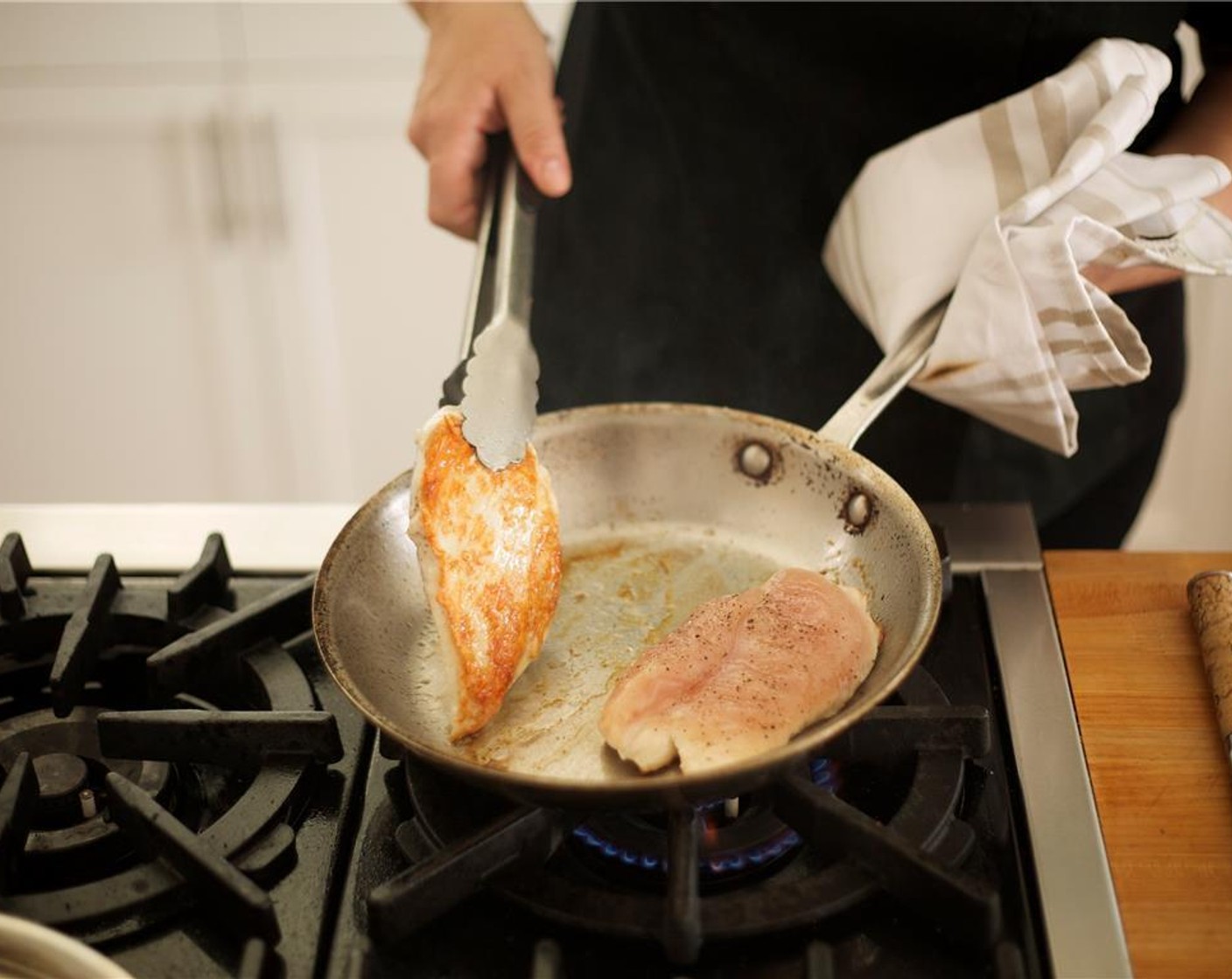 step 3 Pat dry Chicken Breasts (2) with paper towels and off-trim excess fat. Heat a sauté pan over medium-high heat with Olive Oil (1 Tbsp). Season chicken on both sides with Salt (to taste) and Ground Black Pepper (to taste). Cook for 4-5 minutes on one side until golden brown.