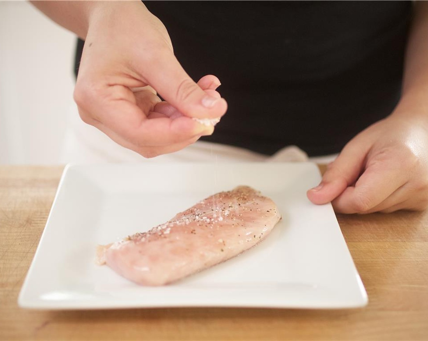 step 4 Pat Tyson® Chicken Breast (1) dry and season with 1/4 teaspoon each of salt and pepper.