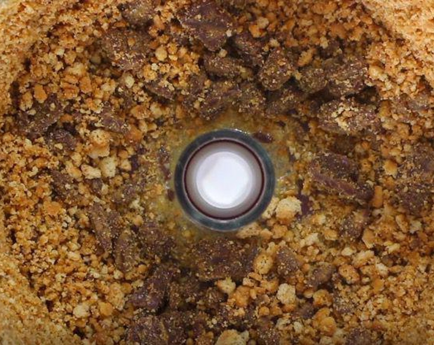 step 1 In a food processor, pulse the Digestive Biscuits (15), Butter (1/3 cup), and Dark Chocolate (1/3 cup) until crumbled.