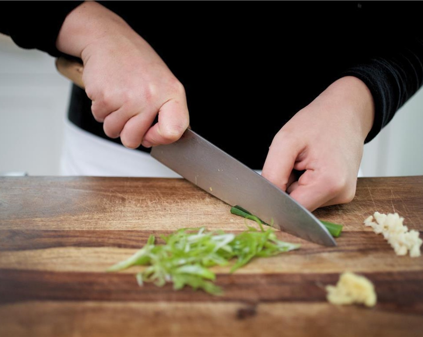 step 4 Mince the Garlic (2 cloves) divide in half. Using the back of a spoon or a peeler, peel and mince the Fresh Ginger (1 Tbsp). Slice the Scallion (1 bunch) diagonally. Set aside.