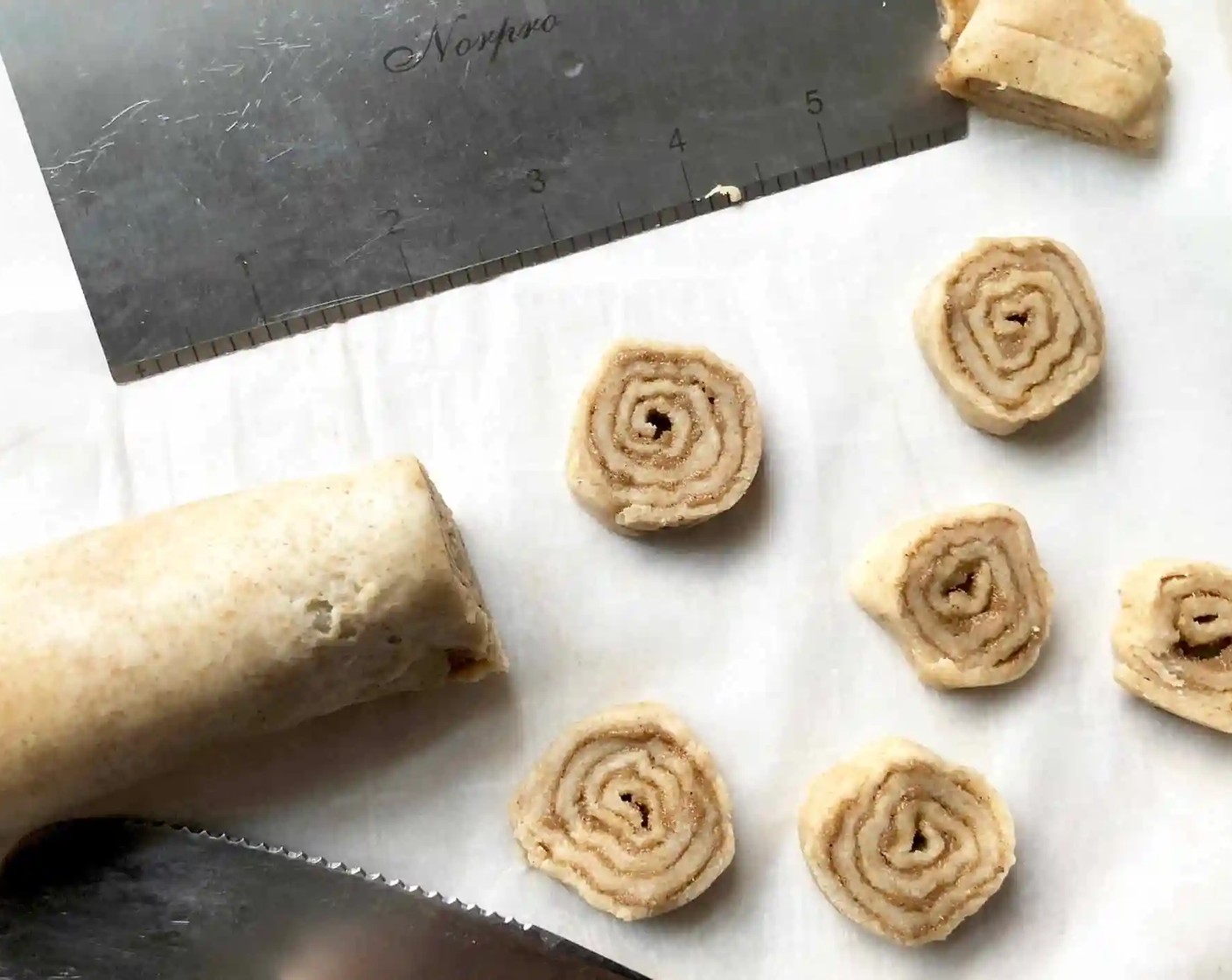 step 11 Using a serrated knife, cut the dough log into 1/4-inch thick slices, rotating with each slice to keep slices round.