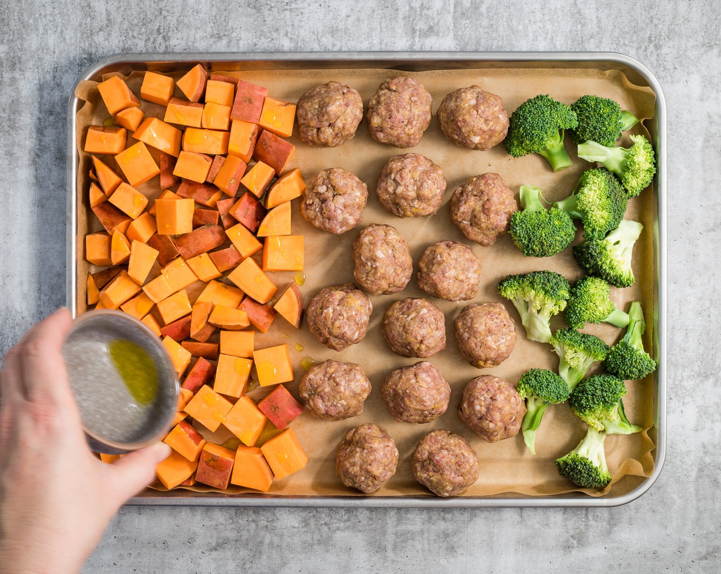step 3 Put the Sweet Potatoes (2), Broccoli (1 head), and meatballs onto the lined pan, making a separate section for each ingredient. Drizzle the vegetables with the Olive Oil (1 Tbsp) and sprinkle with Kosher Salt (1 tsp).
