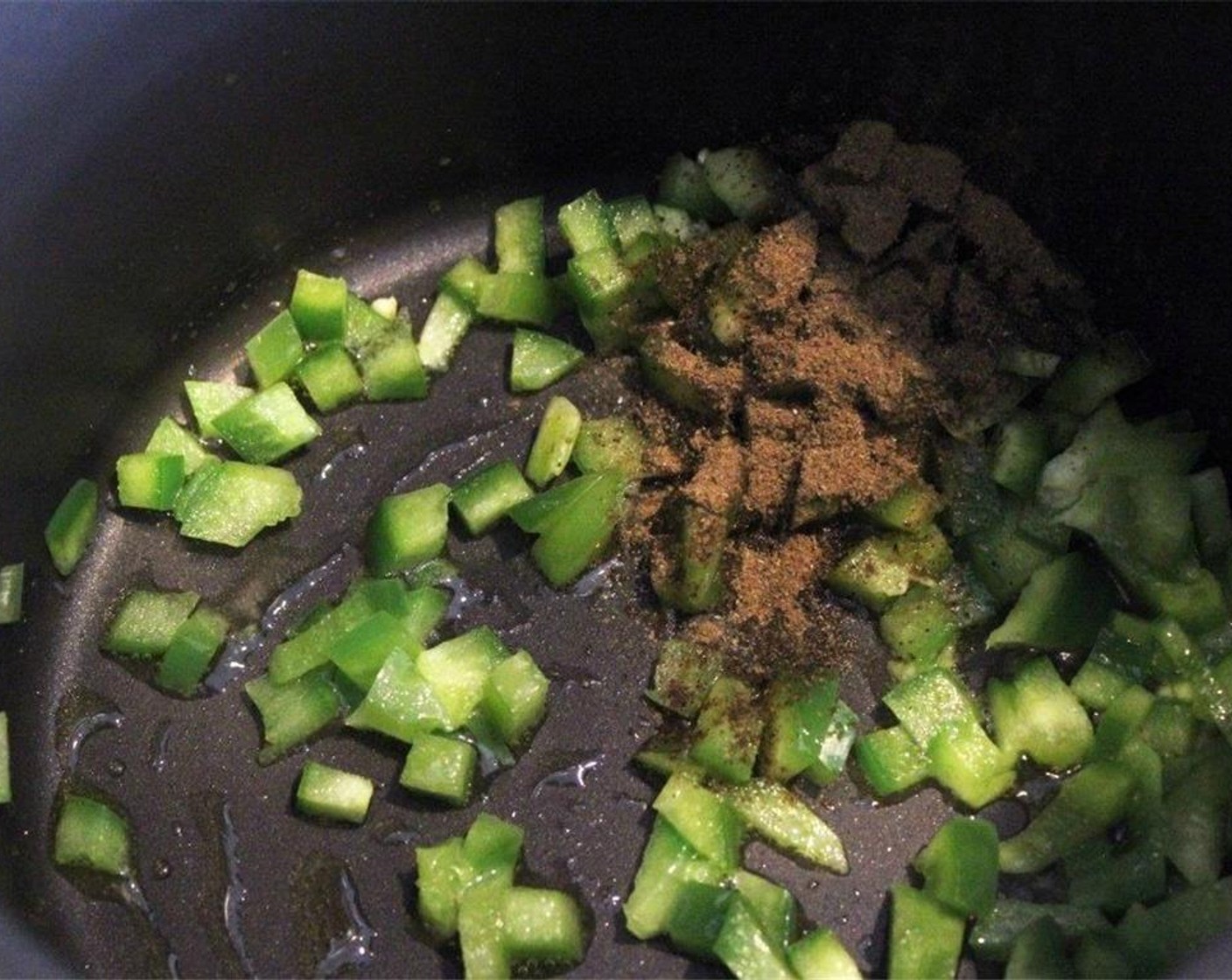 step 4 In the same pot you'll use to cook the rice, add the green bell pepper and Ground Cumin (1 tsp) to the pot over medium heat with a drizzle of oil.