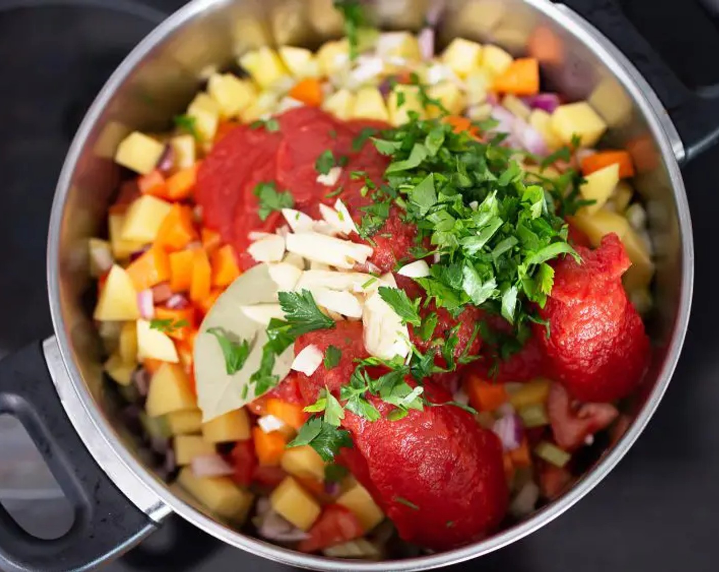 step 1 Place the Potatoes (3), Tomatoes (2), Onions (2), Carrots (2), and Celery (2 sticks) into a large saucepan and add the Canned Tomatoes (1 can), Garlic (1 clove), Bay Leaves (2), Dried Oregano (1/2 tsp),and Fresh Parsley (3 1/2 Tbsp).