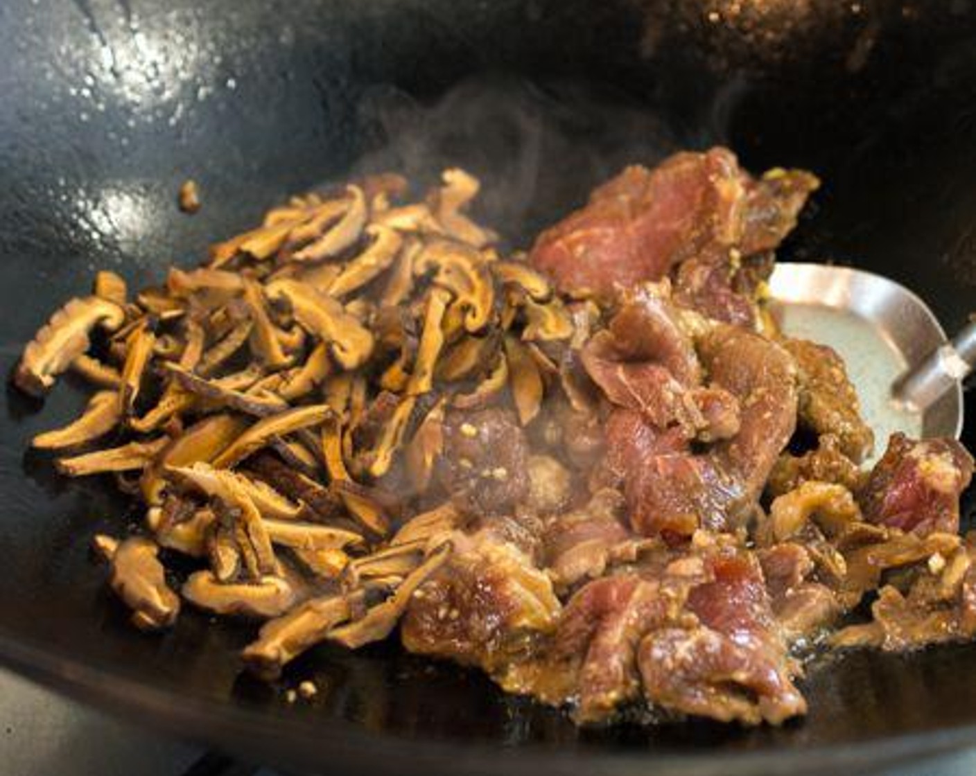 step 6 Stir-fry beef and mushrooms until cooked. Set aside.