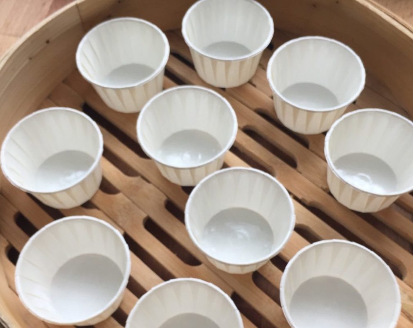 step 12 First, arrange paper cups in bamboo steamer.