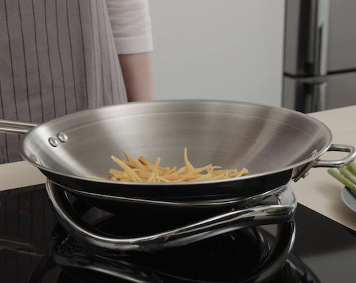 step 7 Add the Carrots (2 tsp) to the wok first. Stir-fry for about 20 seconds.