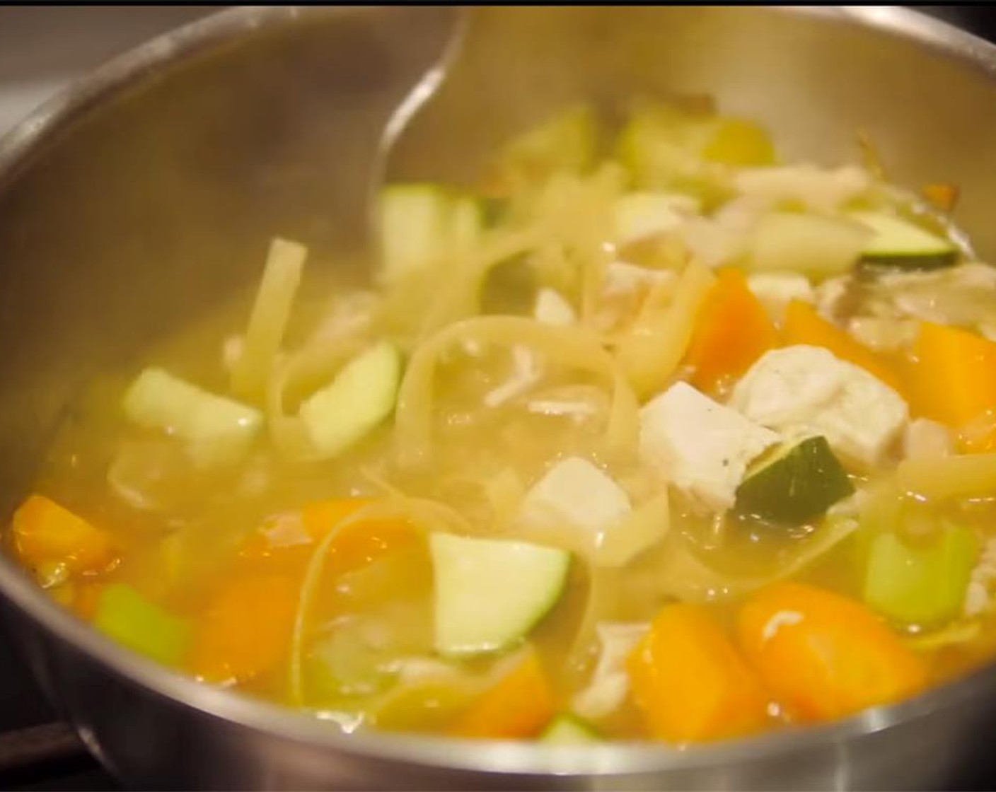 step 9 Once vegetables are 3/4 done, add the chicken along with Fettuccine (2 handfuls). Crush the noodles as you add them to the pot. Mix well, season with Sea Salt (to taste) and cook until pasta is done.