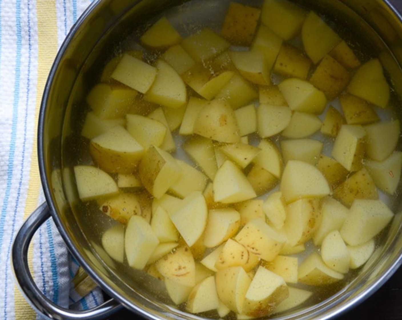 step 3 Cut the Yukon Gold Potatoes (4 1/2 cups) into one-inch pieces. No need to peel them. Fill a large pot halfway with water. Add the Kosher Salt (1/2 tsp) and bring to a boil. When the water boils, add the potatoes and cook for 15 minutes.