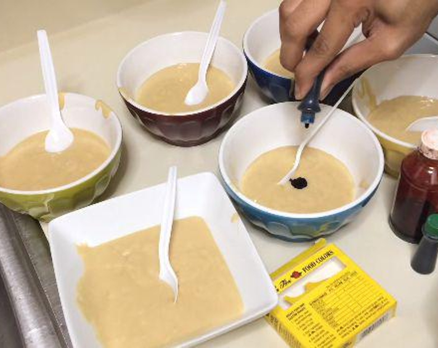 step 4 Divide the cake into 6 bowls. Add enough drops of Blue Food Coloring (to taste), Red Food Coloring (to taste), Yellow Food Coloring (to taste), Orange Food Coloring (to taste), Green Food Coloring (to taste), Purple Food Coloring (to taste) to each bowl. Mix until you have reached your desired color.