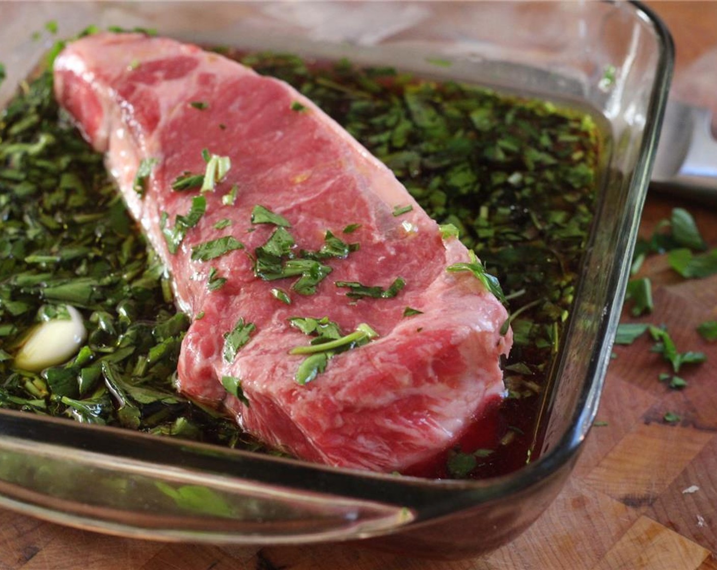 step 2 Cut the Dry-Aged Strip Steak (3 lb) into 4 steaks. Trim each of excess fat, sinew and bone. Marinate steaks in garlic, Cabernet Sauvignon (1/2 cup), Olive Oil (1 Tbsp) and parsley. Marinate for 24 hours.