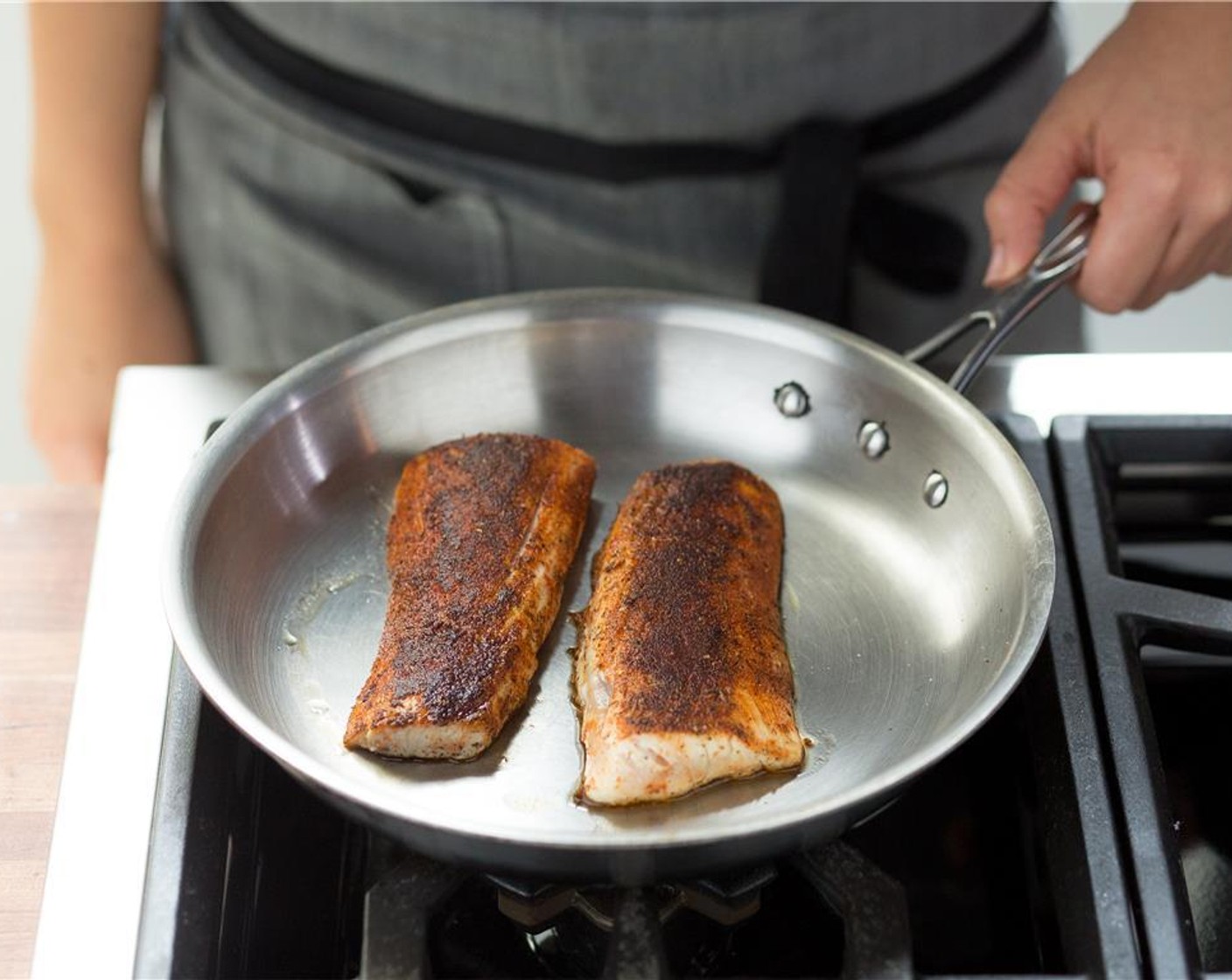 step 8 Heat a medium oven proof saute pan over medium high heat and add Olive Oil (1 Tbsp). When oil is hot, add the mahi mahi fillets spice side down, and sear for three minutes.