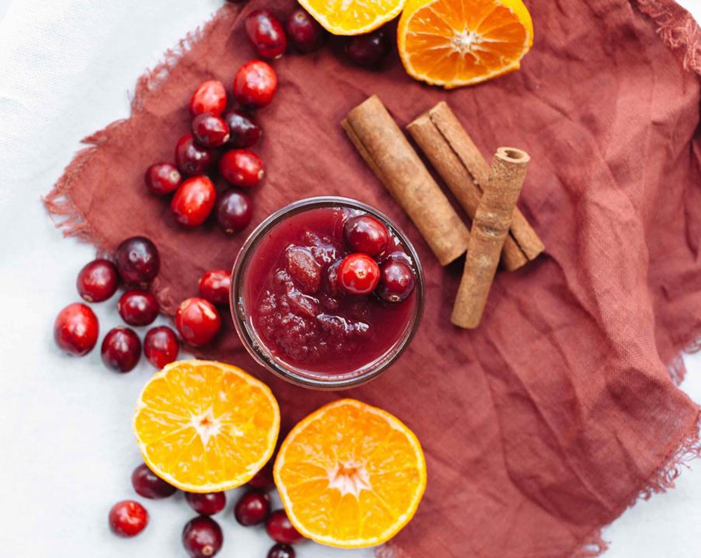 step 1 Add Fresh Cranberries (7 cups), Granulated Sugar (3/4 cup), Oranges (2) juice and zest, Vanilla Extract (1 tsp), Cinnamon Sticks (2) to slow cooker and stir. Cook for 4 hours on high. Once ready, mash cranberries to your liking. Remove and let sit for a few minutes; the cinnamon cranberry sauce should thicken up a bit.