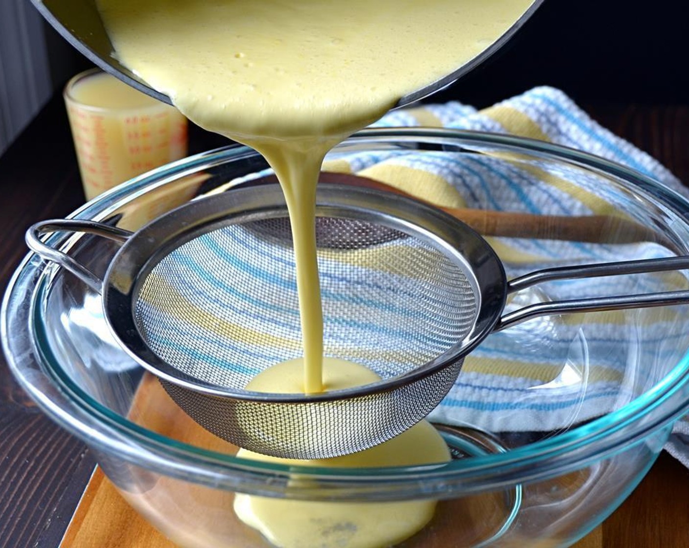 step 7 Place a fine mesh strainer over a medium bowl and pour the custard mixture through the strainer.