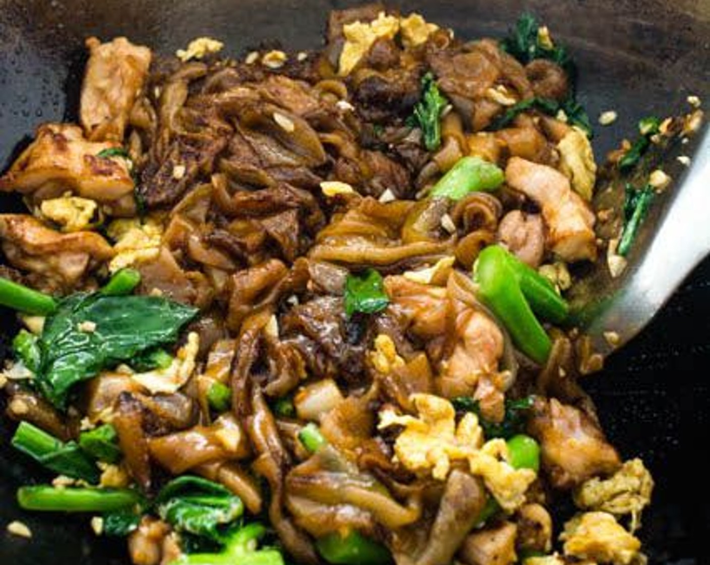 step 15 Return the chicken, Chinese broccoli and egg to the wok. Toss to combine all ingredients, then transfer to a serving plate.