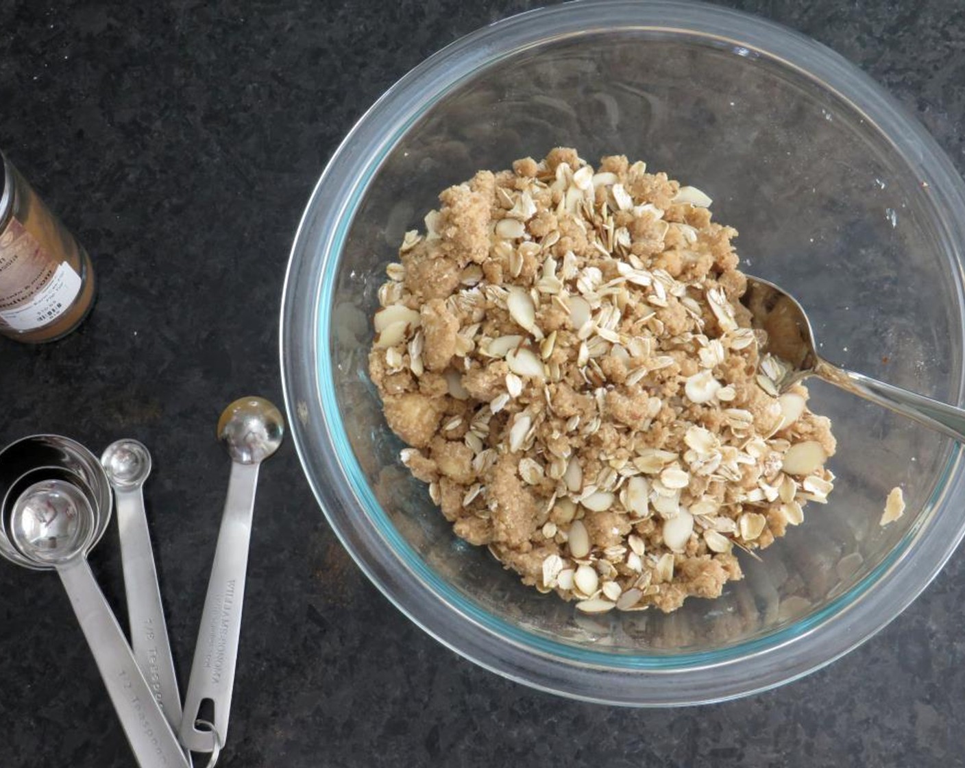 step 5 With your fingers, rub the butter into the flour mixture, working until it resembles wet sand. Add Oatmeal (1/2 cup) and Sliced Almonds (1/4 cup). Toss to combine. Transfer fruit mixture to an 8x8 ceramic baking dish.