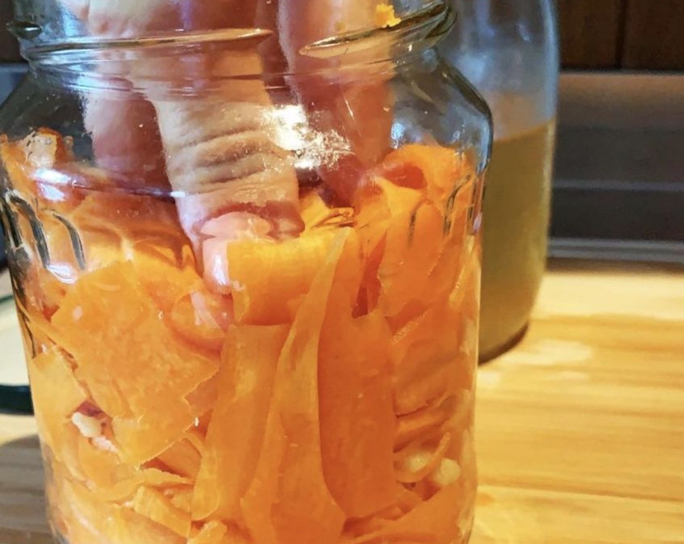 step 3 In a bowl, mix carrots, ginger, and Himalayan Rock Salt (1 tsp), then add the ingredients into your sterilized glass jar, pressing them down with your clean hands or a wooden spoon.