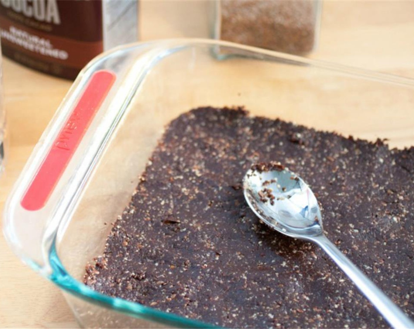 step 2 Transfer to a greased 8x8-inch baking dish and press the crust down with the back of a spoon until it is firm and even.