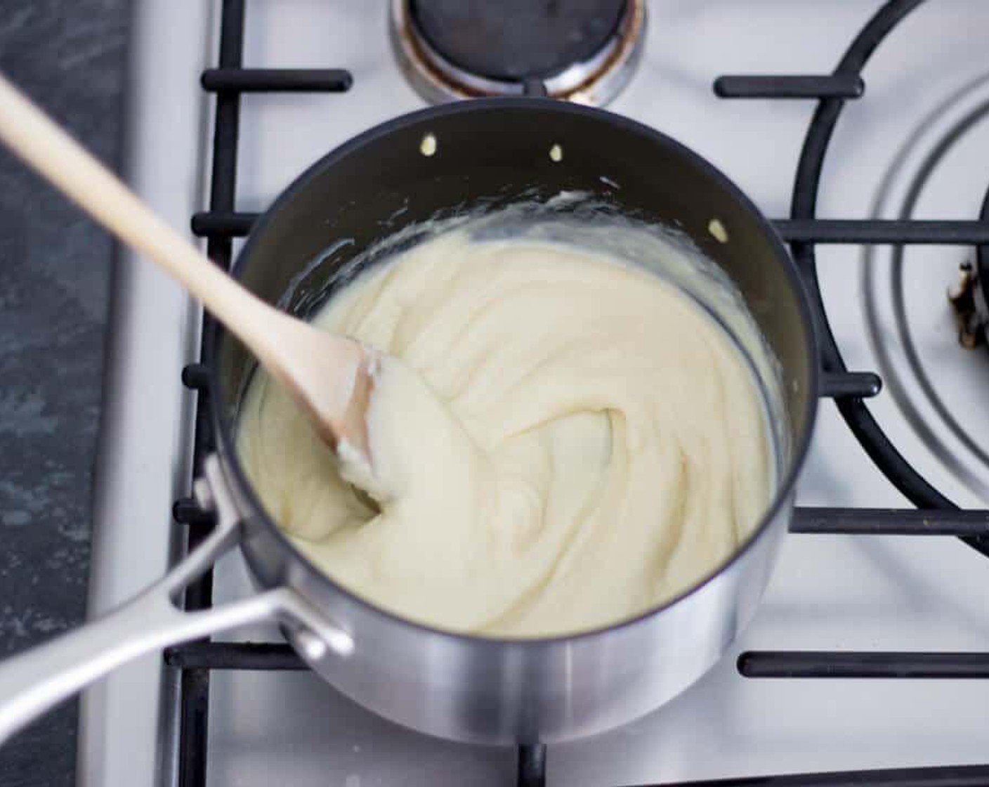 step 6 When you have added all the milk, bring it up to the boil and simmer gently whilst stirring continuously. Keep simmering until your sauce reaches a nice and thick consistency. This should take about 5 minutes.