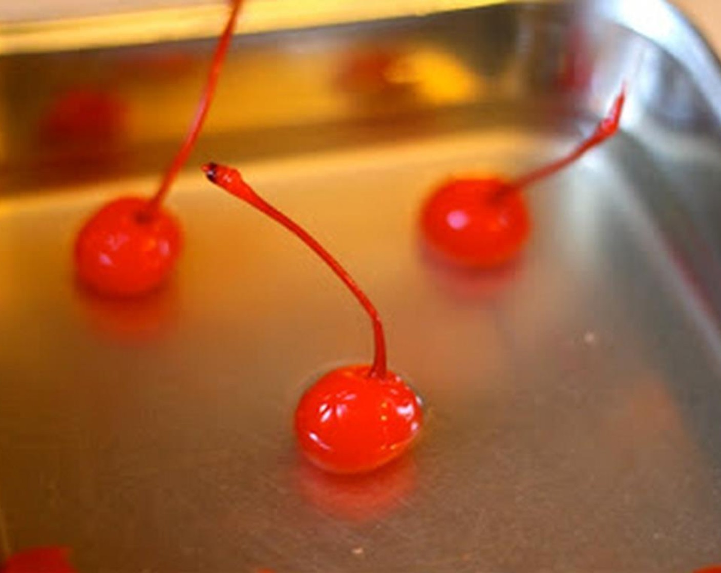 step 4 Dry off Maraschino Cherries (to taste) and gently shave off the bottom of the cherry so they will stand upright.