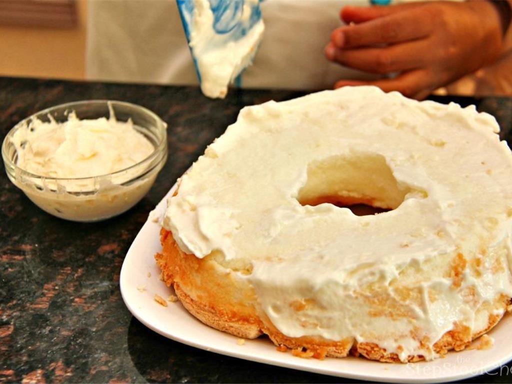 Step 4 of YaYa's No-Bake Strawberry Shortcake Recipe: Spread half the Whipped Cream (1 1/2 cup) on the bottom half of the cake on the top and sides as you would when icing a cake.