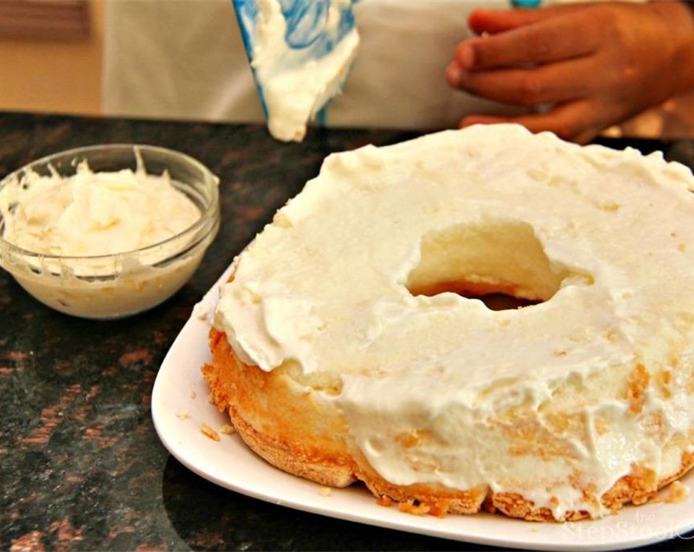 step 4 Spread half the Whipped Cream (1 1/2 cups) on the bottom half of the cake on the top and sides as you would when icing a cake.