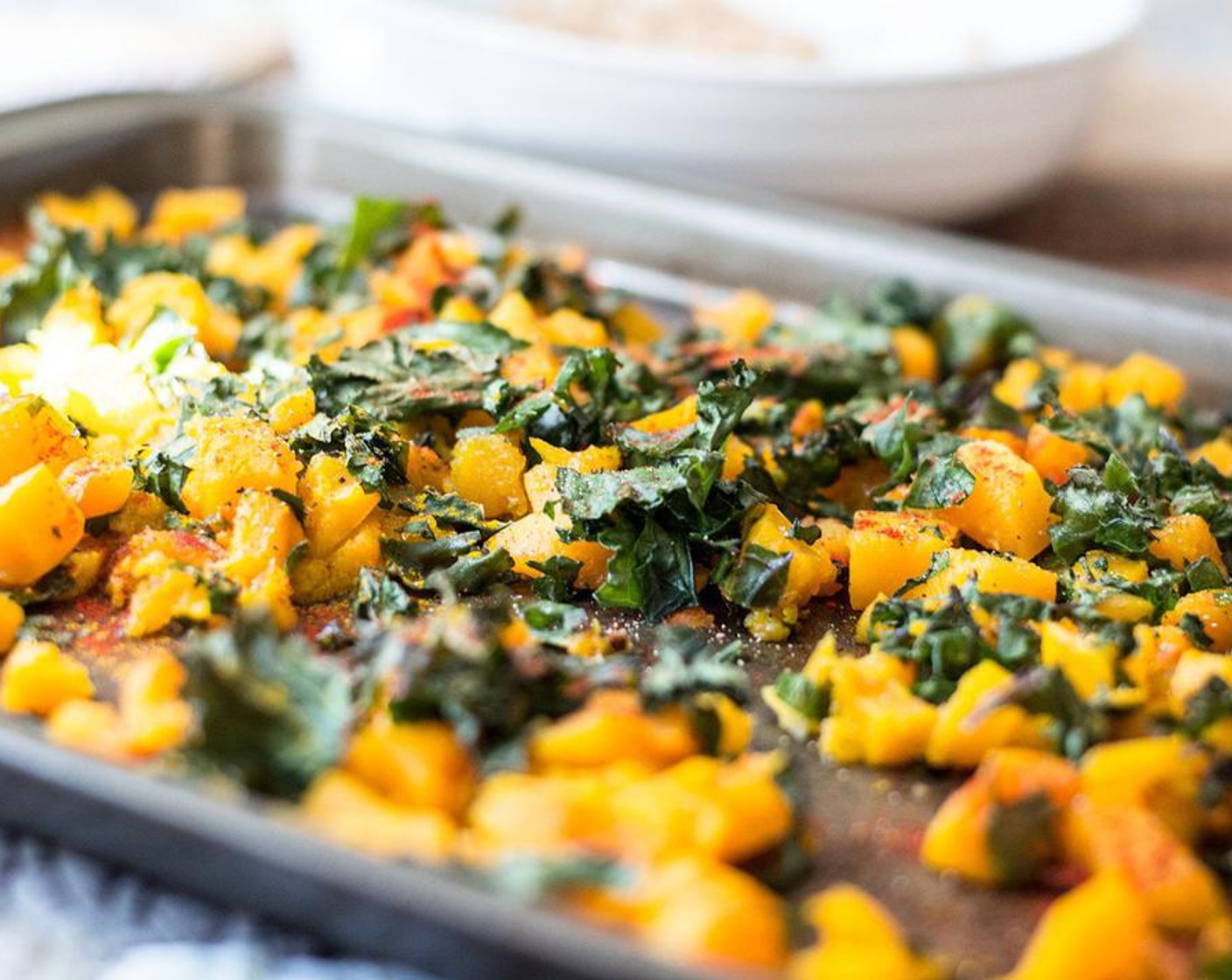 step 4 Remove from oven and add Kale (2 cups) to pan, toss to combine with spatula or wooden spoon, then return butternut squash and kale to oven and bake another 5-6 minutes or until squash is soft and baked through.