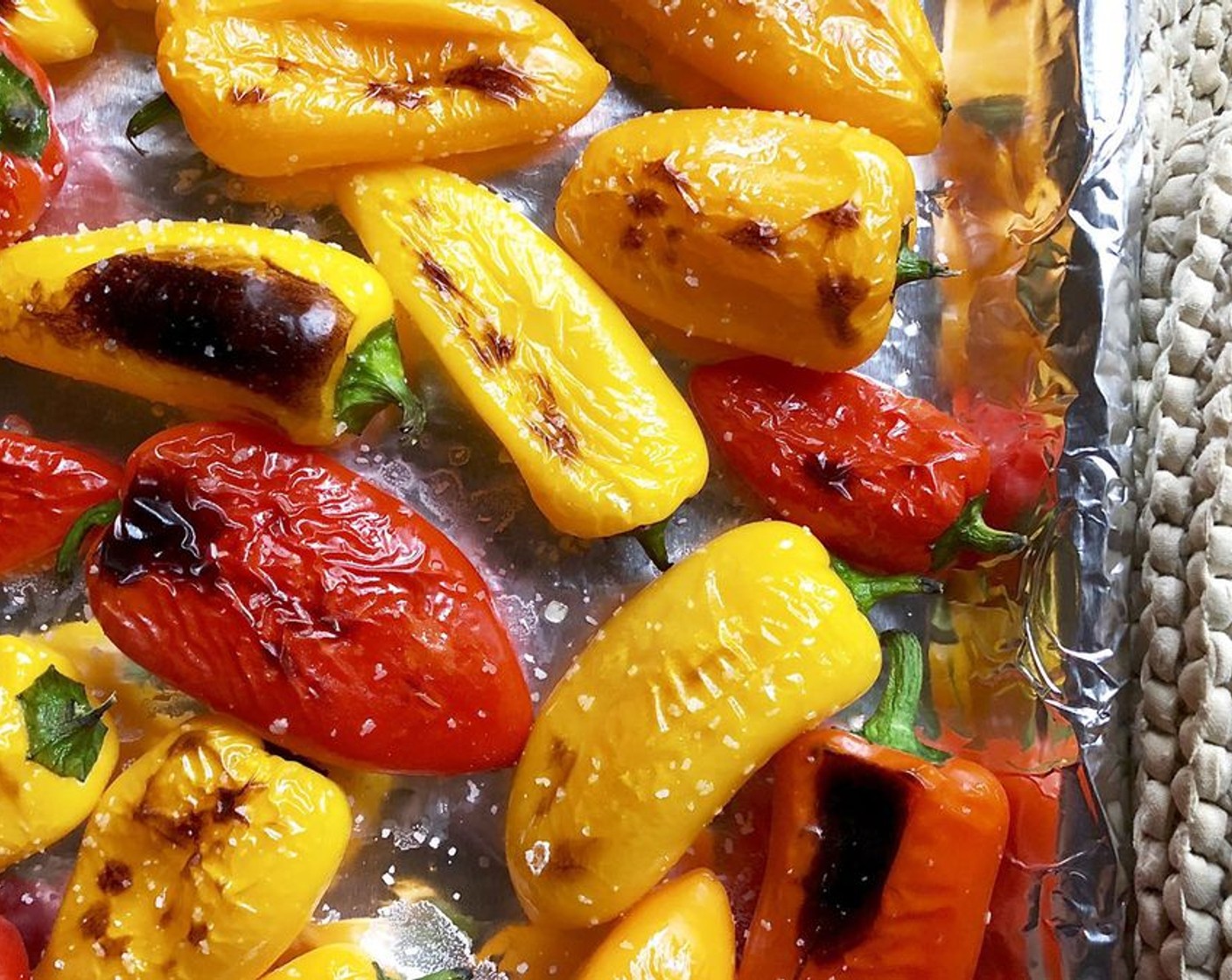 step 4 Using the same foil-lined baking sheet, flip over each pepper so that the charred side is on the bottom.