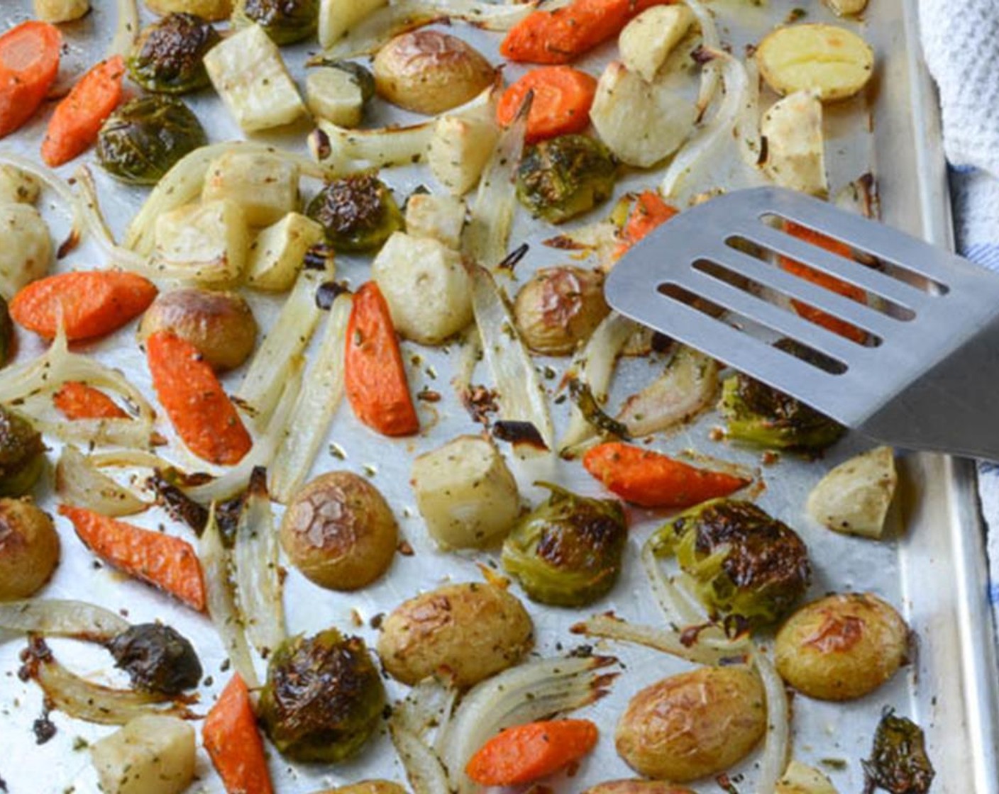 step 7 Roast for 25 to 30 minutes, then use a metal spatula to flip the vegetables over.