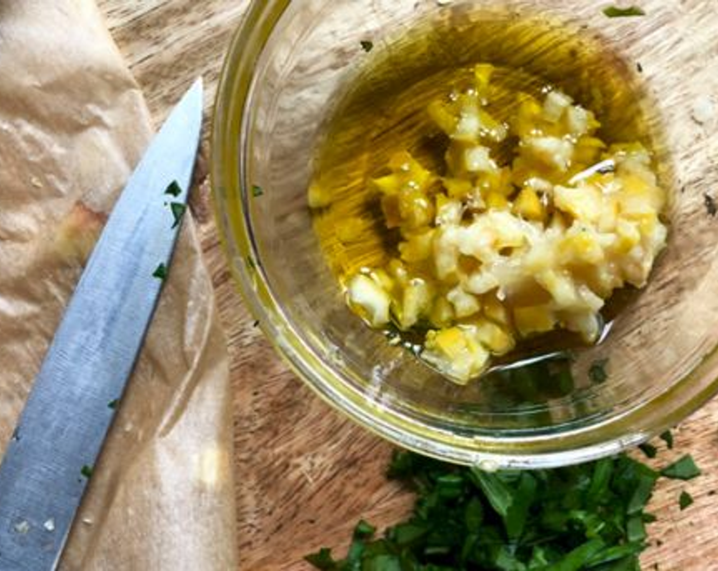 step 7 Meanwhile, finely chop half or all of the roasted lemon (peel and all) and add to a small bowl along with the remaining Olive Oil (2 Tbsp), Fresh Basil (2 Tbsp), and a pinch of salt.