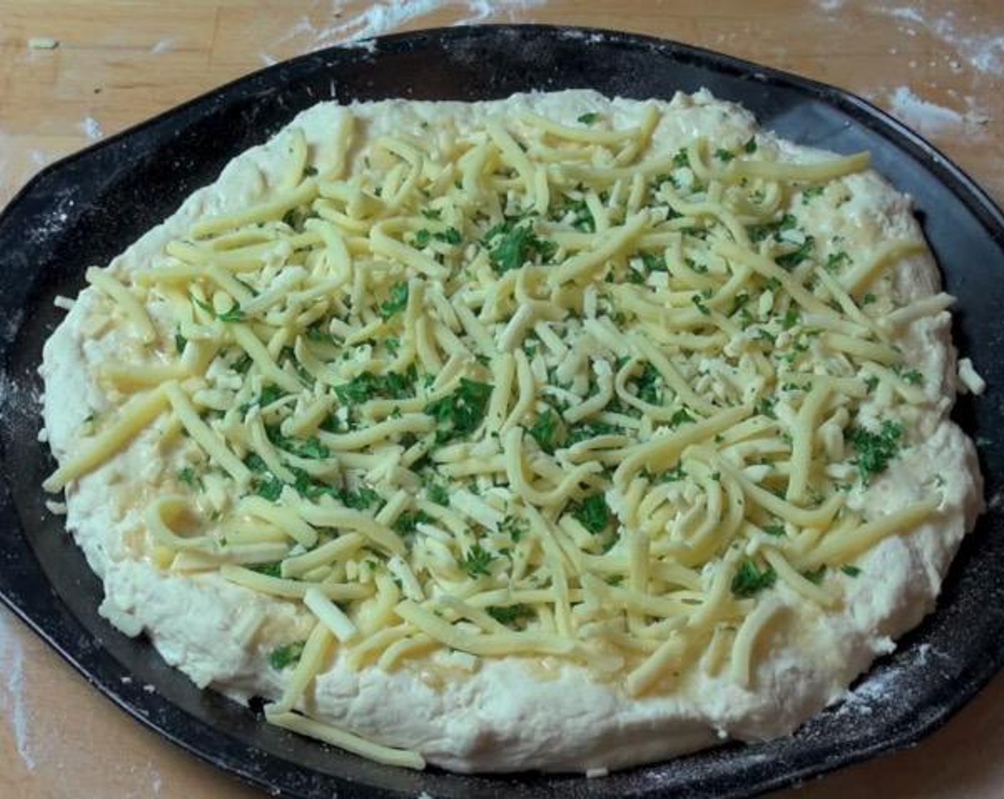 step 3 In a small cup, combine Olive Oil (4 Tbsp) and Garlic (2 cloves). Spread mixture over the dough. Sprinkle Fresh Parsley (2 Tbsp) and Cheese (1 cup) over top.