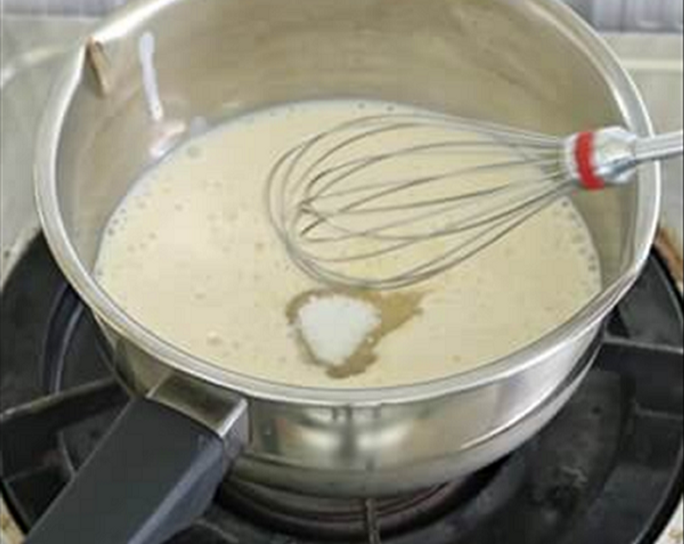 step 5 For the soya Milk Pudding - Combine the Unsweetened Soy Milk (1 1/3 cups) and Caster Sugar (3 1/2 Tbsp) in a pot. Lightly boil the soya milk and stir the sugar till dissolved at low heat.