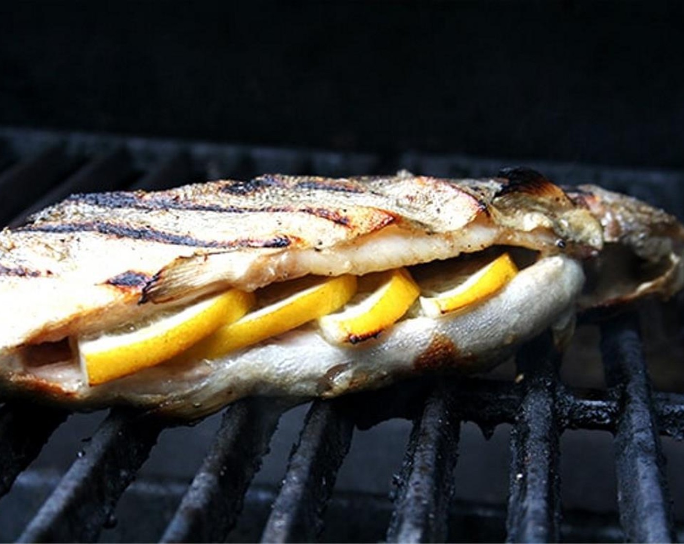 step 2 Season Whole Trout (2) all over with Kosher Salt (to taste) and Ground Black Pepper (to taste). Stuff the cavity with half-moon slices of Lemon (1). Rub Olive Oil (as needed)  all over the fish. (Alternatively, rub oil over your grill grates.)