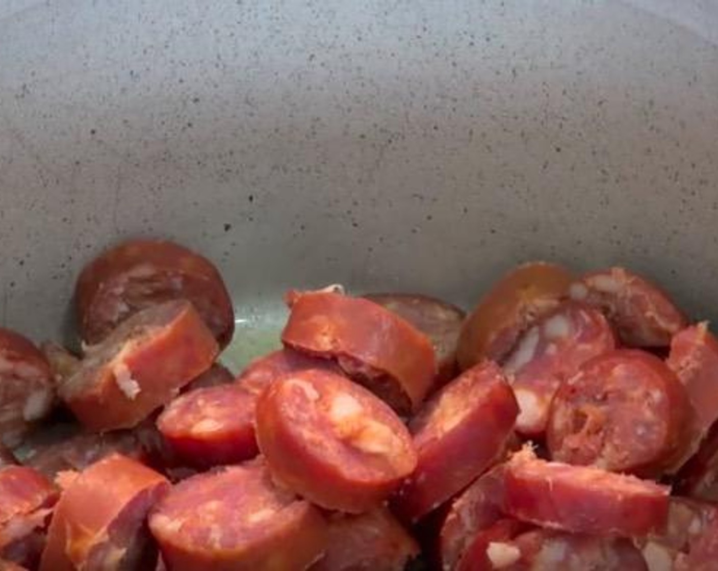 step 1 Take a large saucepan with a little bit of oil, add the Spanish Chorizo (5) and cook it for about 5 minutes. Then transfer them into a bowl and set aside. Add a little bit more oil and add Yellow Onions (2), Garlic (2 cloves), Paprika (2 tsp), Ground Cumin (1 tsp), Red Chili Pepper (1), and stir together for 2 minutes in medium heat.