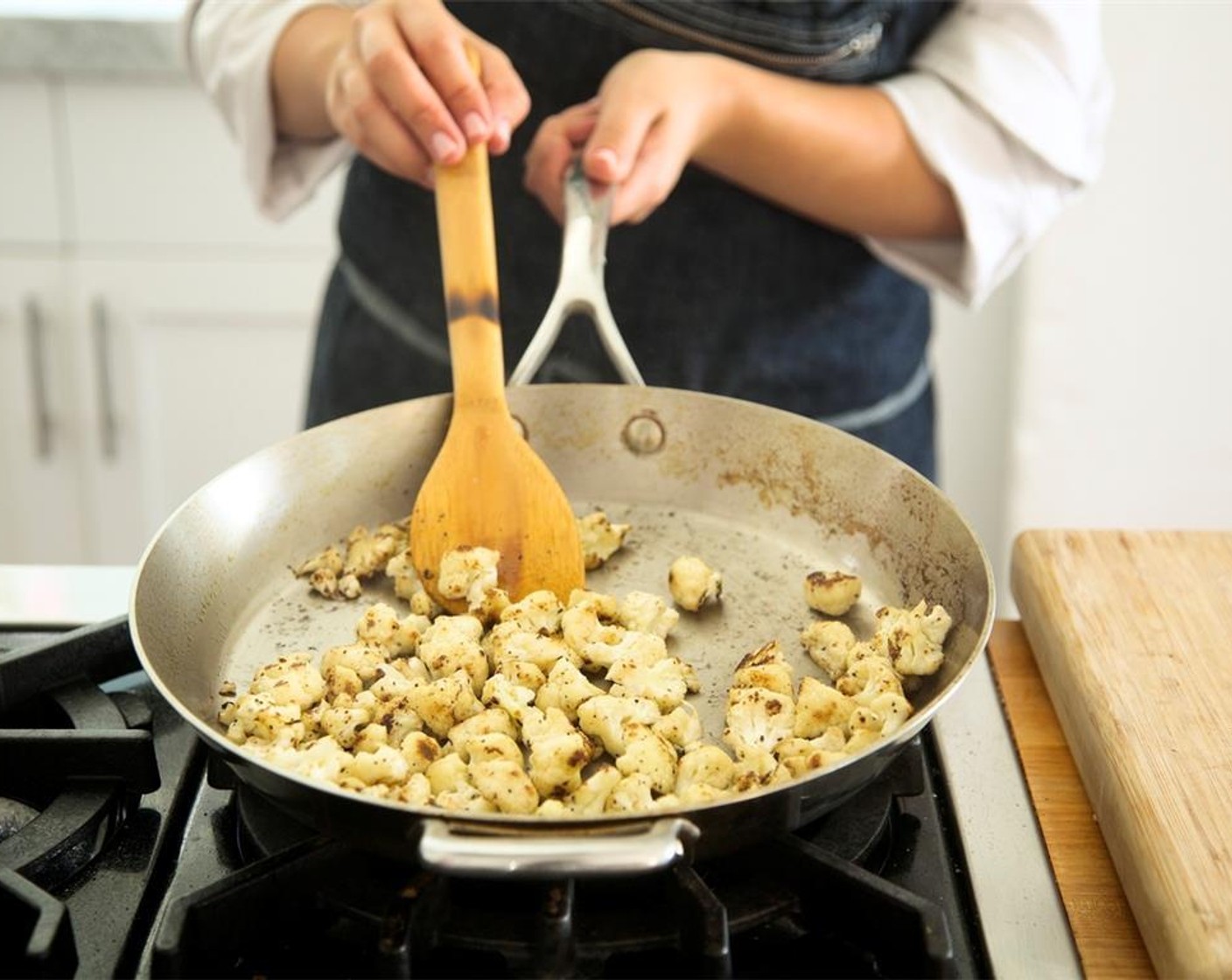 step 7 In a large saute pan, heat Olive Oil (2 Tbsp) over medium high heat. Once oil is hot, add cauliflower florets with Salt (1/2 tsp) and Ground Black Pepper (1/4 tsp). Cook for approximately seven minutes, until cauliflower is golden brown.