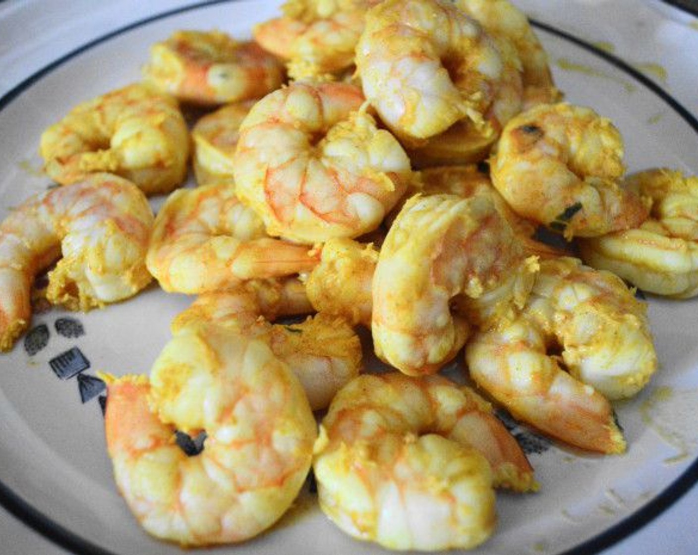 step 4 Transfer the shrimp into the hot pan, marinade and all. Cook the shrimp for about 2 minutes on each side, until pink and opaque. Remove them with a slotted spoon and set them aside.