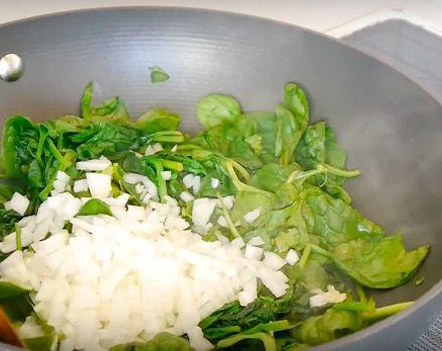 step 3 Grate the Garlic (4 cloves), Fresh Ginger (2 tsp) over the spinach and add the White Onions (2) Salt (to taste), and Ground Black Pepper (to taste) and leave to cook until the spinach has completely wilted, about 5 minutes. Once cooked, remove from the heat and leave to cool down.