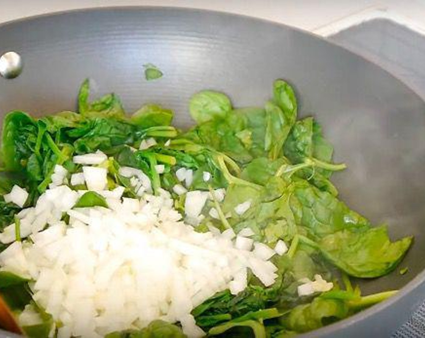 step 3 Grate the Garlic (4 cloves), Fresh Ginger (1/2 Tbsp) over the spinach and add the White Onions (2) Salt (to taste), and Ground Black Pepper (to taste) and leave to cook until the spinach has completely wilted, about 5 minutes. Once cooked, remove from the heat and leave to cool down.