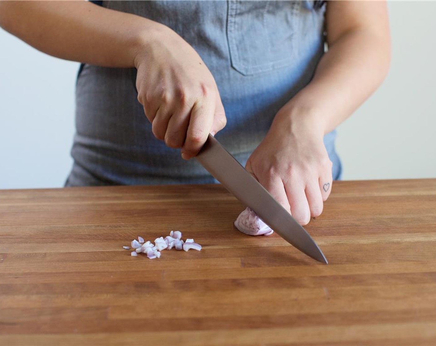 step 2 Place large saute pan on the stove top over low heat. Finely chop the Shallot (1) and place in a medium bowl. Remove the Fresh Mint (1/3 cup) leaves from the stems and discard stems. Roughly chop mint leaves and place in the same bowl as the shallots.