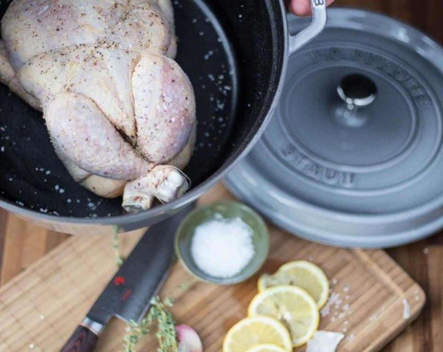 step 5 Stuff the cavity with Lemon (1) cut into halves, Fresh Thyme (8 sprigs), and Garlic (1/2 head) (smashed but skin left on). Truss the bird so that the legs seal the cavity.