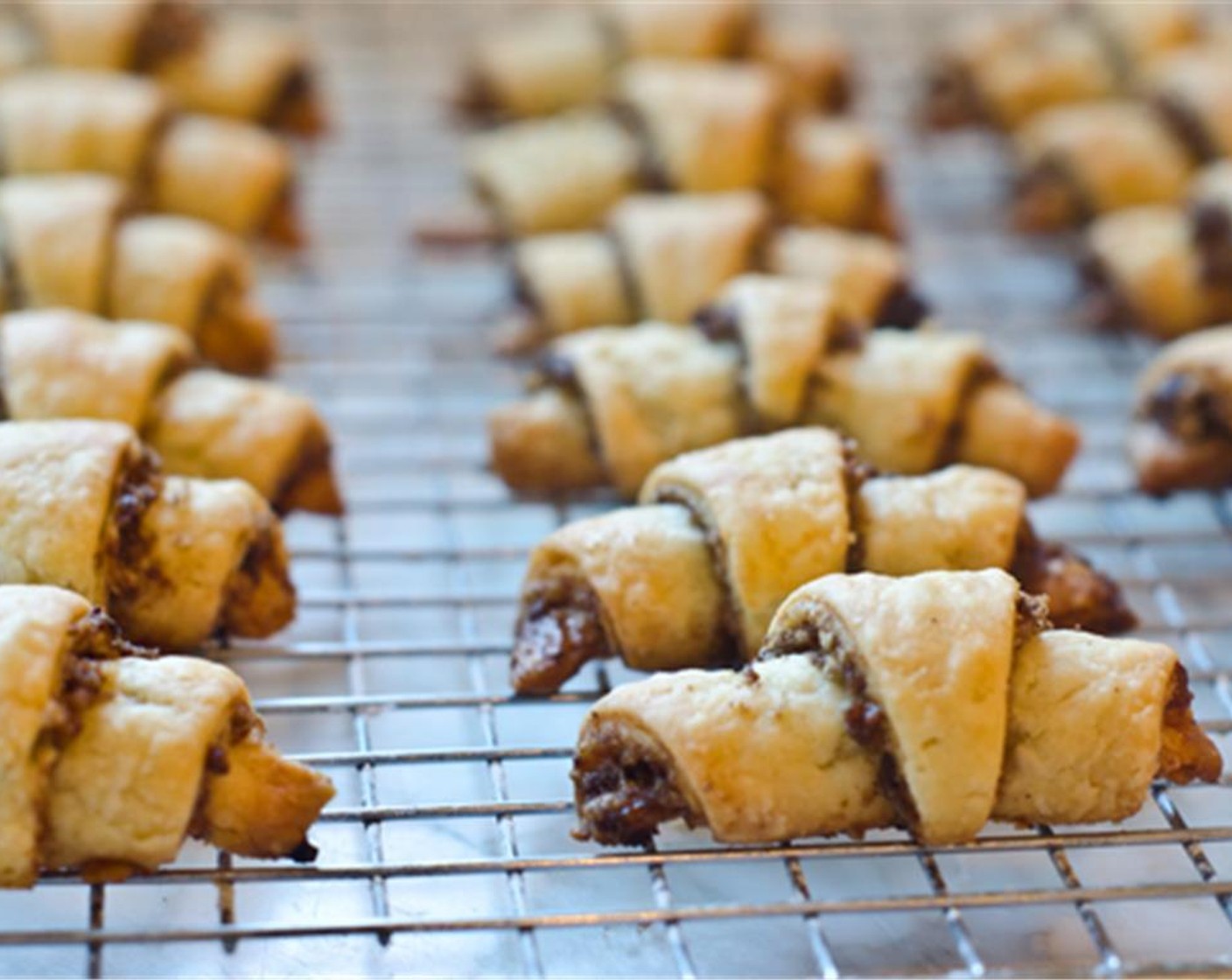 step 11 Bake for 25-30 minutes, or until the tops are lightly golden and the bottoms are golden and crisp.  Transfer the rugelach to a rack to cool. Serve and enjoy!