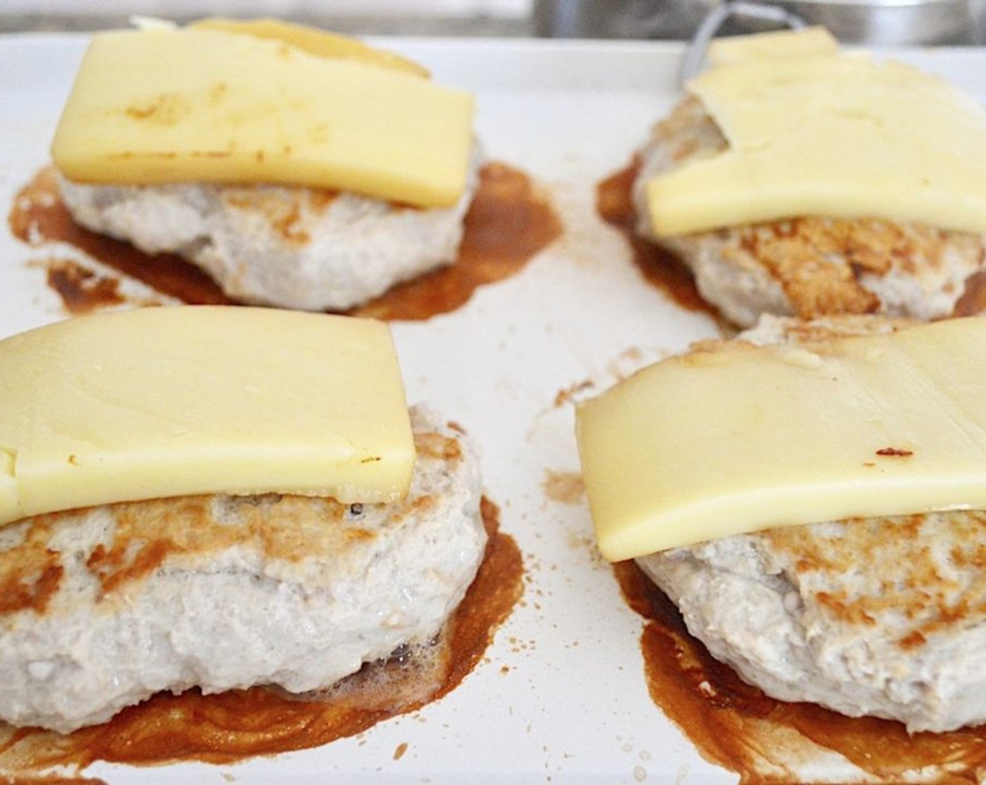 step 6 On the second side, add the Smoked Gruyere Cheese (6 slices) and cover the burgers so that it melts nicely.