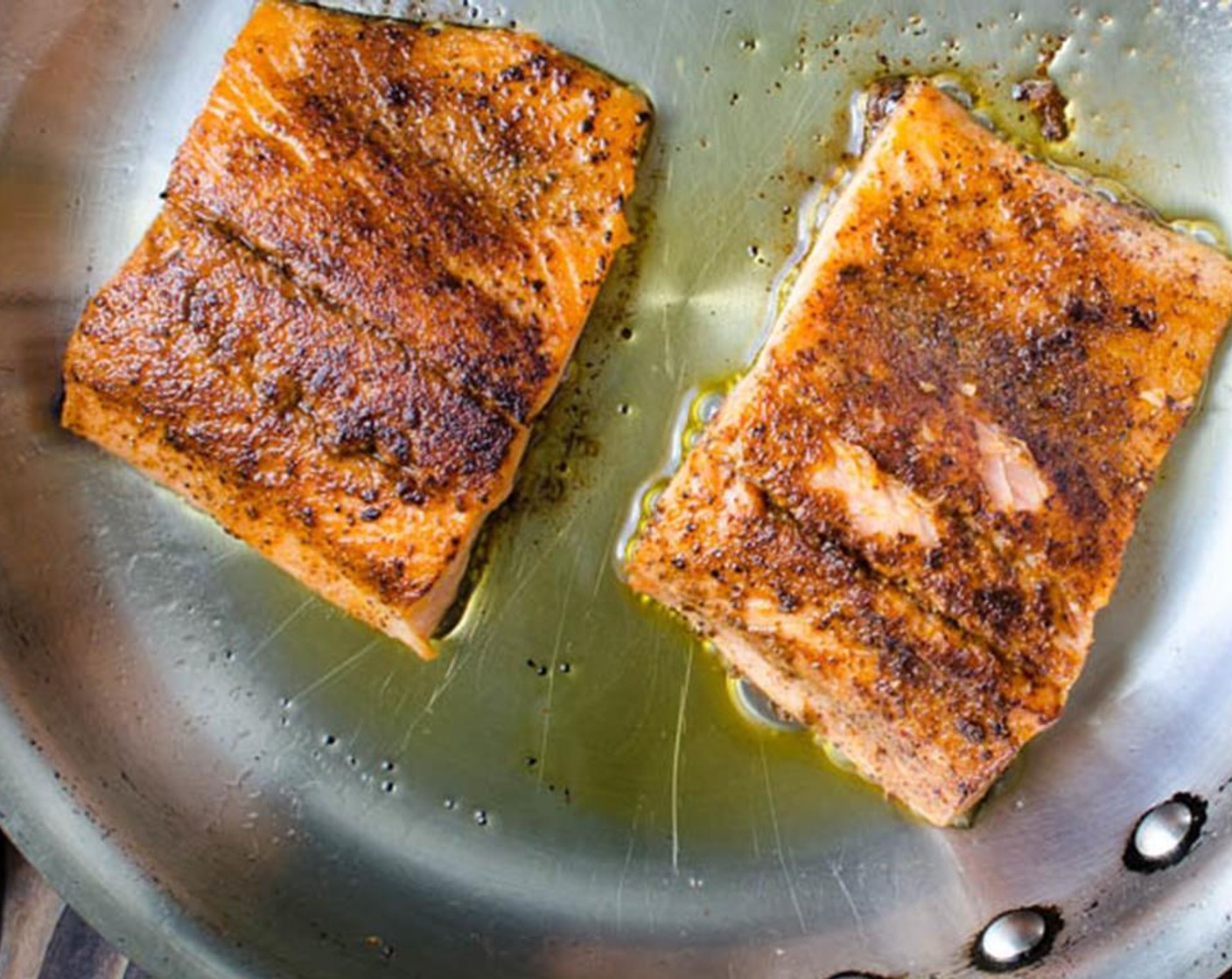 step 9 Add one tablespoon sesame oil to another pan over medium high heat. When pan is very hot, carefully place the salmon, flesh side down in the pan. Cook for 1-2 minutes.