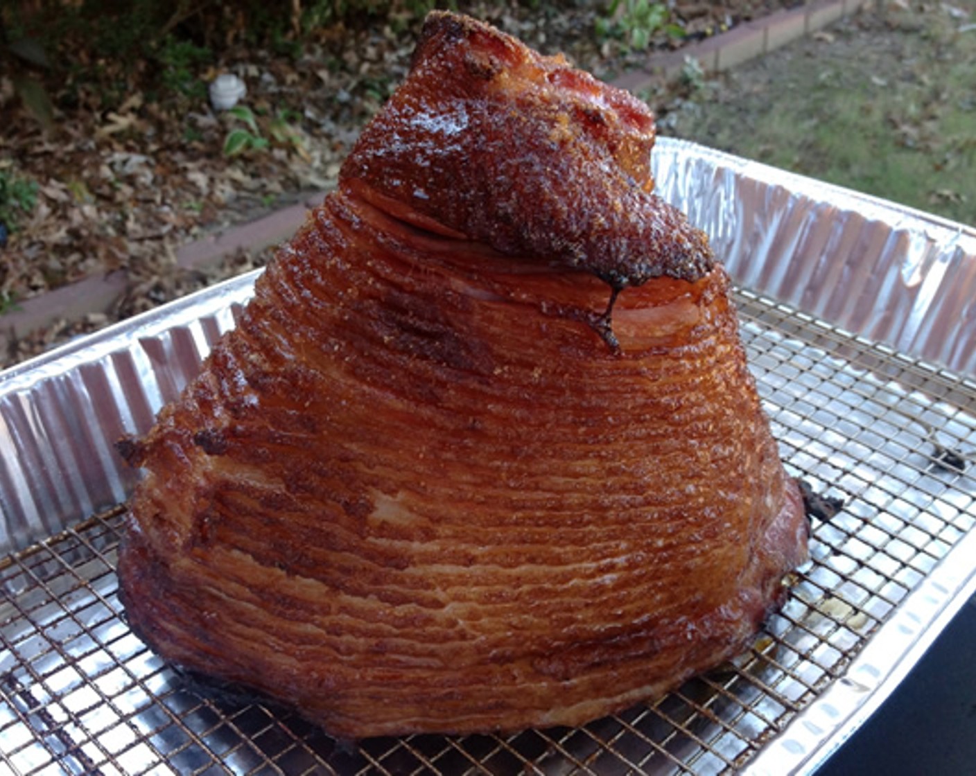 step 7 You can tell when the ham is ready because the slices will start to separate slightly and the outside will have that caramelized look. When it reaches this point, remove the ham from the smoker and loosely tent with aluminum foil.
