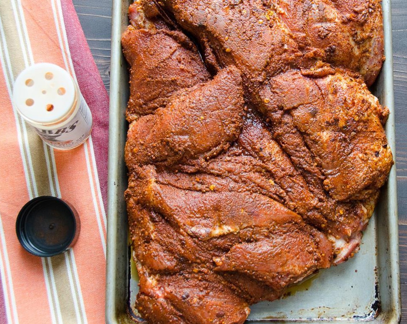 step 2 Place pork on a baking sheet and liberally spread the whole jar of Pork Rub (1 jar) over both sides of the flesh, massaging it in with your hands. Cover with plastic wrap and refrigerate overnight.