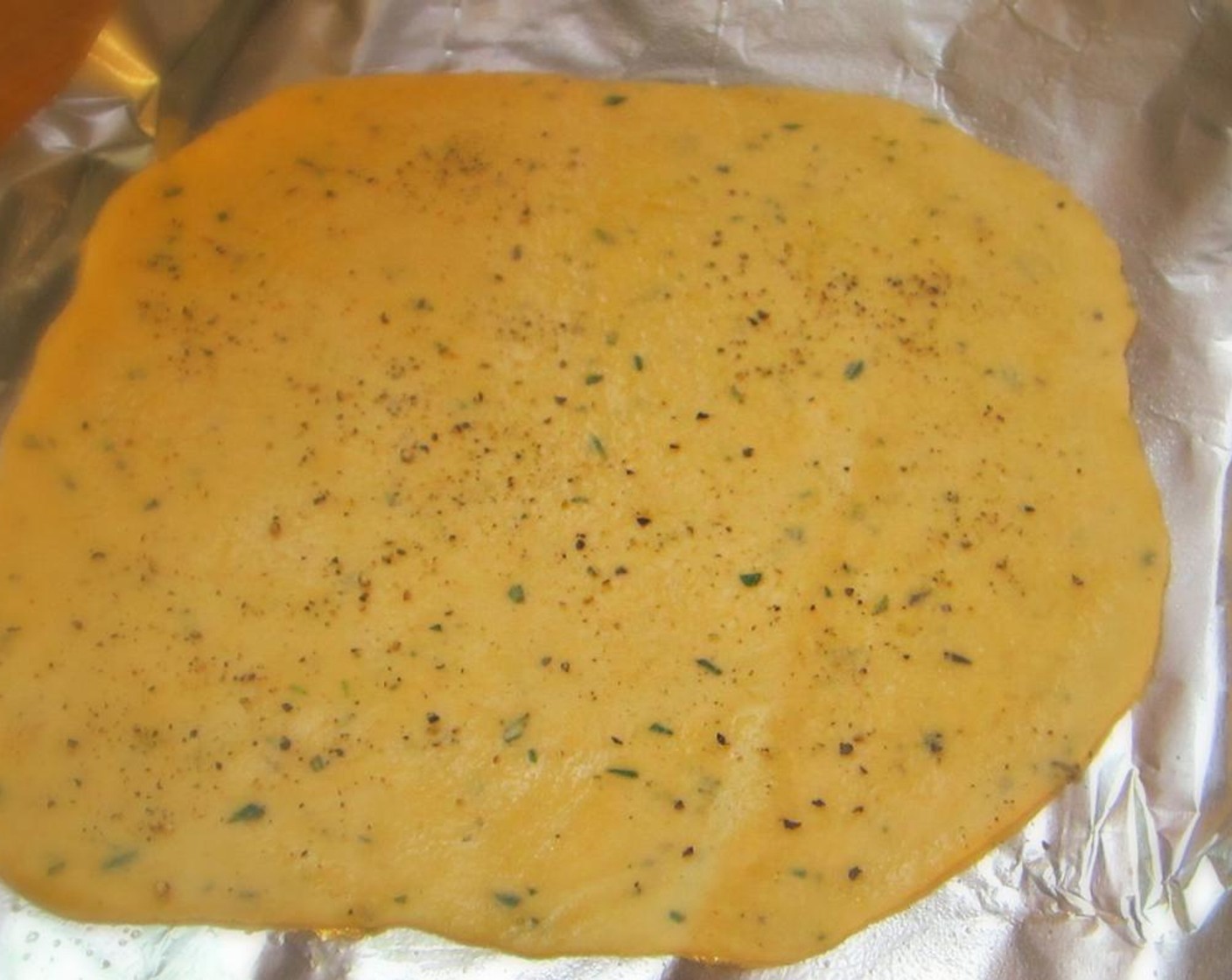 step 7 Once the dough is rolled out, lightly brush the top with additional oil and sprinkle with sea salt or table salt. Sprinkle with sea salt. Slide the rolled out dough onto a preheated baking sheet and bake until pale golden and browned in spots, 8-10 minutes.